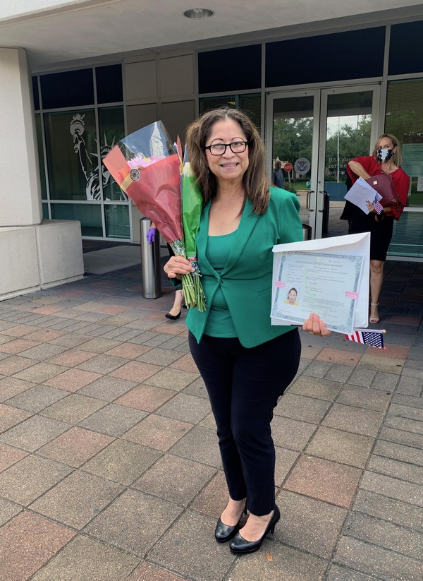 M. celebrates the fact that she is now a citizen; she is extremely joyous.